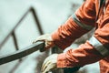 Closeup of a person wearing industrial clothing and gloves