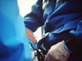 Closeup of a person in a wheelchair being restrained by a policeman representing the overpolicing of disabled people in