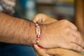 Closeup of a person& x27;s hand wearing a bracelet - Raksha Bandhan
