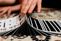 Closeup of person's hands shuffling the card deck on the table Royalty Free Stock Photo