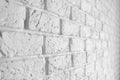 Closeup perspective view of a decorative rough white brick wall background