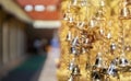 Closeup and perspective view group of small golden bells hang in Thai temple Royalty Free Stock Photo