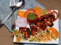 Closeup of a Peshawari paneer tikka served with fork and spoon