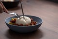 Closeup of pesto conchiglie with sundried tomatoes and cutting burrata cheese served in blue bowl