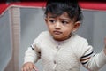 closeup photo of an adorable baby indian boy with worried face