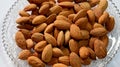 Closeup photo of Almond on a plate,health benefits,highly nutrious,vitamins,minerals and antioxidants ,white background
