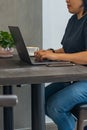 Closeup photo of woman`s hand typing laptop at coffee table Royalty Free Stock Photo