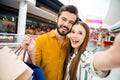 Closeup photo of attractive funny lady handsome guy couple visit shopping store mall together carry many bags packs