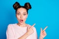 Closeup photo of attractive pretty shocked lady two funny buns direct finger side empty space showing novelty sale