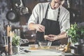 Closeup photo of baker cracking egg for dough. Retro styled imagery