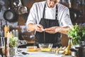 Closeup photo of baker cracking egg for dough. Retro styled imagery