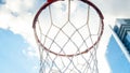 Closeup image of basketball ring with net on sports playground against blue sky with clouds Royalty Free Stock Photo