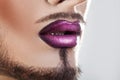 Closeup photo of bearded male lips with makeup