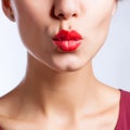 Closeup photo of a beautiful red lips giving kiss