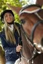 Closeup photo of blonde rider and horse Royalty Free Stock Photo