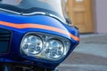 Closeup photo of blue modern motorcycle with stylish batwing and custom headlights. Motorcycle is parked on the city street Royalty Free Stock Photo