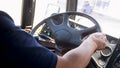Closeup image of bus driver hands holding steering wheel Royalty Free Stock Photo