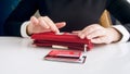 Closeup image of businesswoman taking big stack of credit cards out of wallet Royalty Free Stock Photo