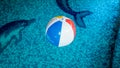 Closeup photo of colorful striped inflatable beach ball floating on the water surface at swimming pool Royalty Free Stock Photo