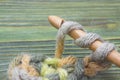 Closeup photo of crochet chain. Rustic crochet thread and a bamboo hook. Warm green winter yarn ball for knitting and crochet on t