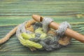 Closeup photo of crochet chain. Rustic crochet thread and a bamboo hook. Warm green winter yarn ball for knitting and crochet on t