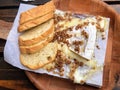 A closeup photo of a delicious meal of Warm Brie, candied pecans, honey, and a baguette