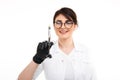 Closeup photo of female dentist holding oral syringe isolated over the white backgrownd.