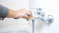 Closeup photo of female hand washing water tap in bathroom with sponge Royalty Free Stock Photo