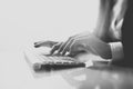 Closeup photo of female hands typing text on a wireless keyboard. Business woman working at the office. Visual effects Royalty Free Stock Photo