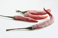 Closeup photo of frozen chilli peppers on white background