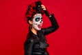 Closeup photo of funny folklore witch, creepy lady calavera with makeup masquerade. Sugar skull girl showing tong, wear floral Royalty Free Stock Photo