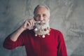Closeup photo of funny old santa claus man colorful toy balls in long beard x-mas decorations after salon wear red Royalty Free Stock Photo