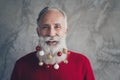 Closeup photo of funny white haired old man with colorful toy balls in long beard decorations wear stylish red pullover Royalty Free Stock Photo