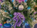 Closeup photo of glittering bulb and ribbon on Christmas tree Royalty Free Stock Photo