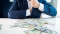 Closeup photo of greedy businessman filling his pockets with money Royalty Free Stock Photo