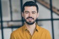 Closeup photo of handsome easy-going person guy standing in modern interior apartments look like office building indoors