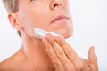 Closeup photo of a handsome man smearing shaving foam on his chin Royalty Free Stock Photo