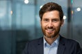 Closeup photo headshot of a mature businessman with a beard looking at the camera and smiling, a successful investor Royalty Free Stock Photo