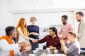 Hindoo employee giving a warm handshake to smiling red-haired woman Royalty Free Stock Photo