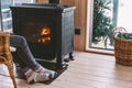 Closeup photo of human feet in warm woolen socks over fire place Royalty Free Stock Photo