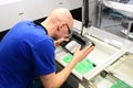 quality control in the production - man checks board for defects - manufacturing in a high tech factory Royalty Free Stock Photo