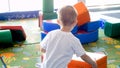 Closeup photo of little boy playing with big soft blocks on playground Royalty Free Stock Photo