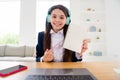 Closeup photo of little student lady talk skype notebook online lesson video call sit desk showing teacher copybook