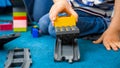 Closeup photo of little toddler boy playing woth toy train and railroad on carpet at playroom Royalty Free Stock Photo