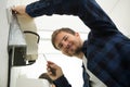 closeup photo male technician installing air conditioning unit Royalty Free Stock Photo