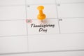 Closeup photo of mark on calendar at twenty-fifth inscription thanksgiving day with yellow pushpin