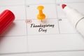 Closeup photo of mark on calendar at twenty-fifth inscription thanksgiving day with yellow pushpin and red felt pen