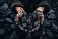 Closeup photo of Miner& x27;s hands holding black coal