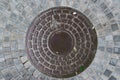 Closeup photo of Old Sewer rust manhole cover on the urban asphalt road. Rain scene.