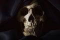 Closeup photo an old skull covered in black robe Royalty Free Stock Photo